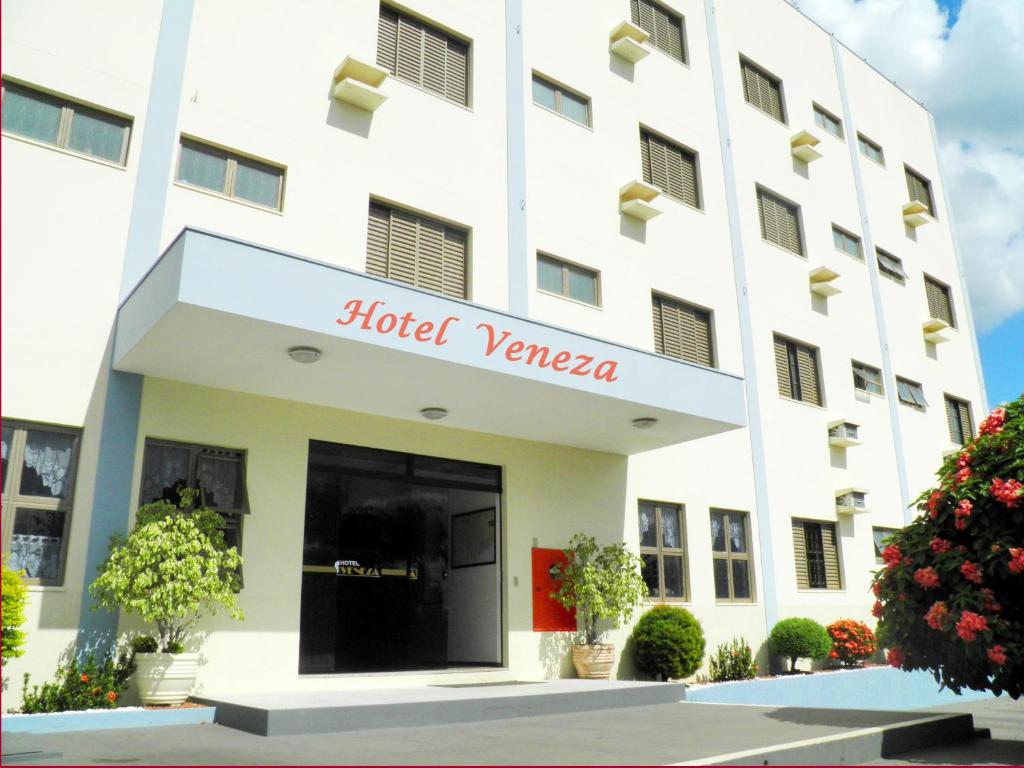 a hotel in front of a building at Hotel Veneza in Ibaté