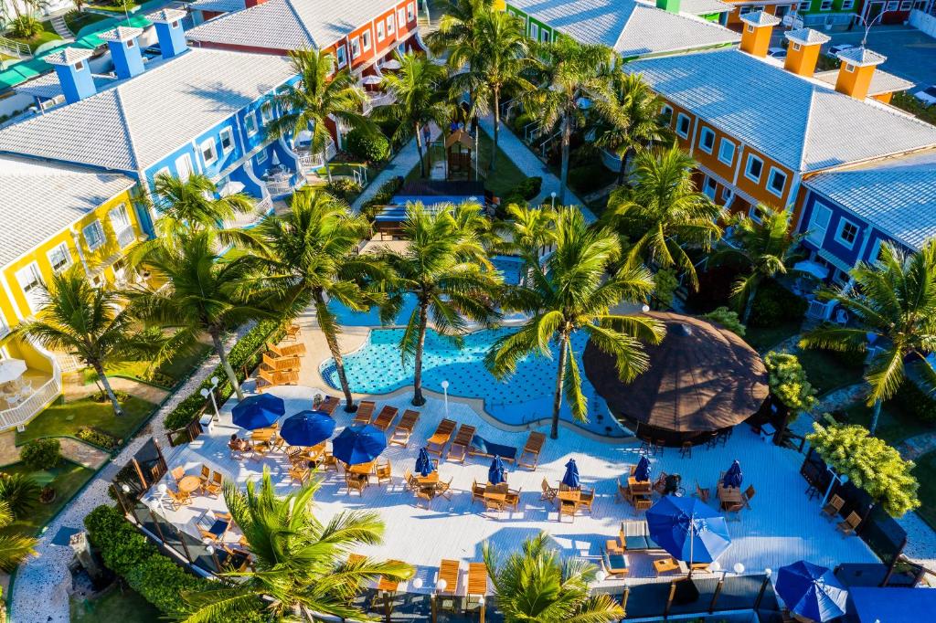 an aerial view of the resort with a pool and palm trees at Hotel Vila do Farol in Bombinhas