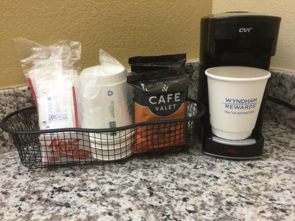 a basket with coffee and other items on a counter at Days Inn by Wyndham Clayton in Clayton