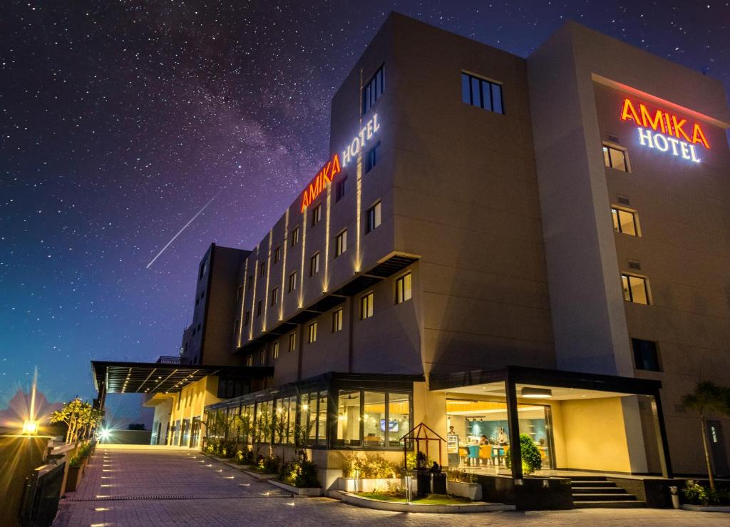 a hotel at night with a starry sky at Amika Hotel,Madurai - Near Airport in Madurai