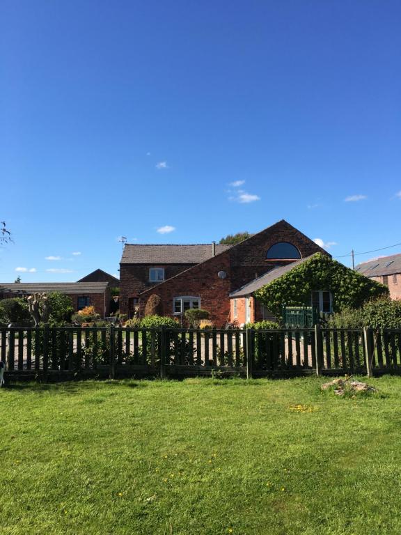 una valla de madera frente a una casa en The Barn Bed and Breakfast en Liverpool