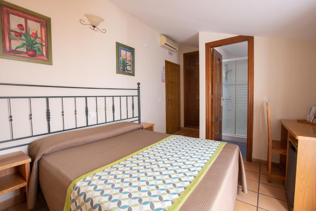 Posteľ alebo postele v izbe v ubytovaní Hostal El Gallo
