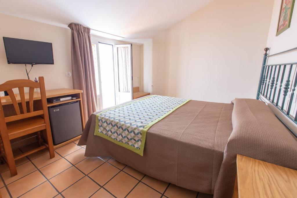Posteľ alebo postele v izbe v ubytovaní Hostal El Gallo
