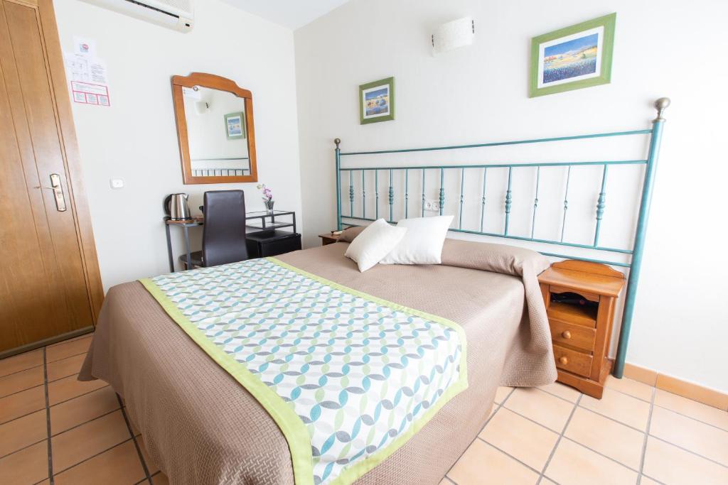 Posteľ alebo postele v izbe v ubytovaní Hostal El Gallo