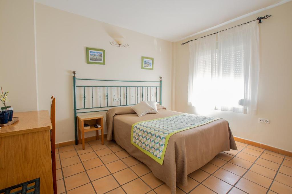 Posteľ alebo postele v izbe v ubytovaní Hostal El Gallo