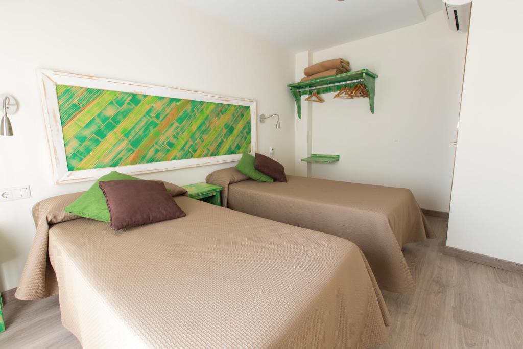 Posteľ alebo postele v izbe v ubytovaní Hostal El Gallo