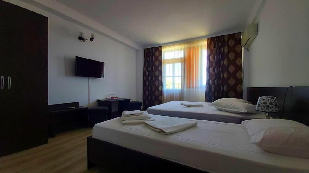 Postel nebo postele na pokoji v ubytování Vila Egreta