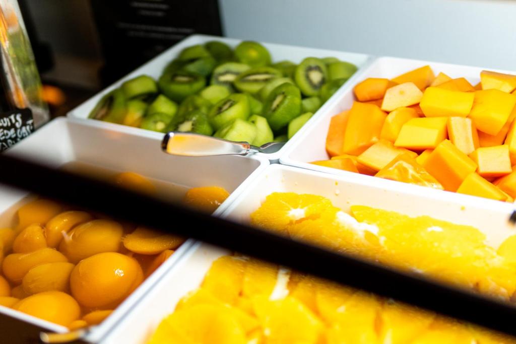 two plastic containers of fruits and vegetables on a table at Parador de La Gomera in San Sebastián de la Gomera