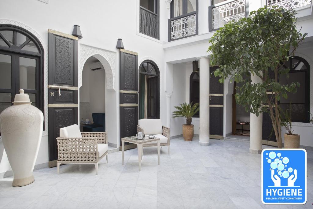 a lobby with chairs and a table in a building at Riad Mirage in Marrakesh