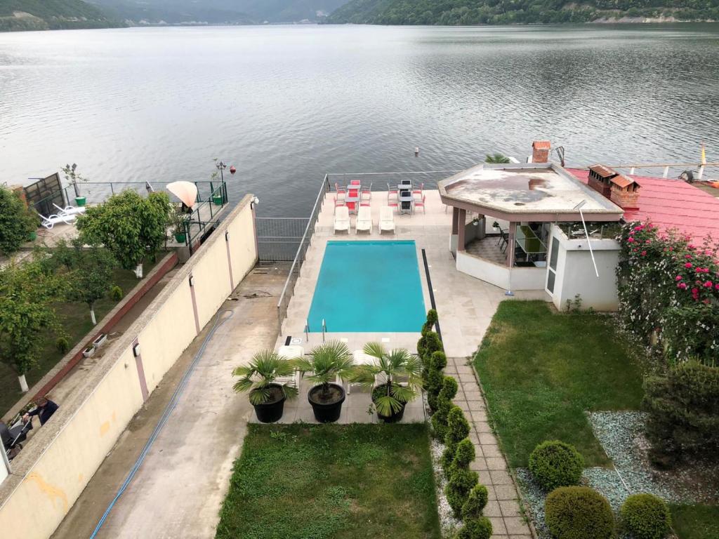 an aerial view of a house on the water with a swimming pool at Casa Doma Orsova in Orşova