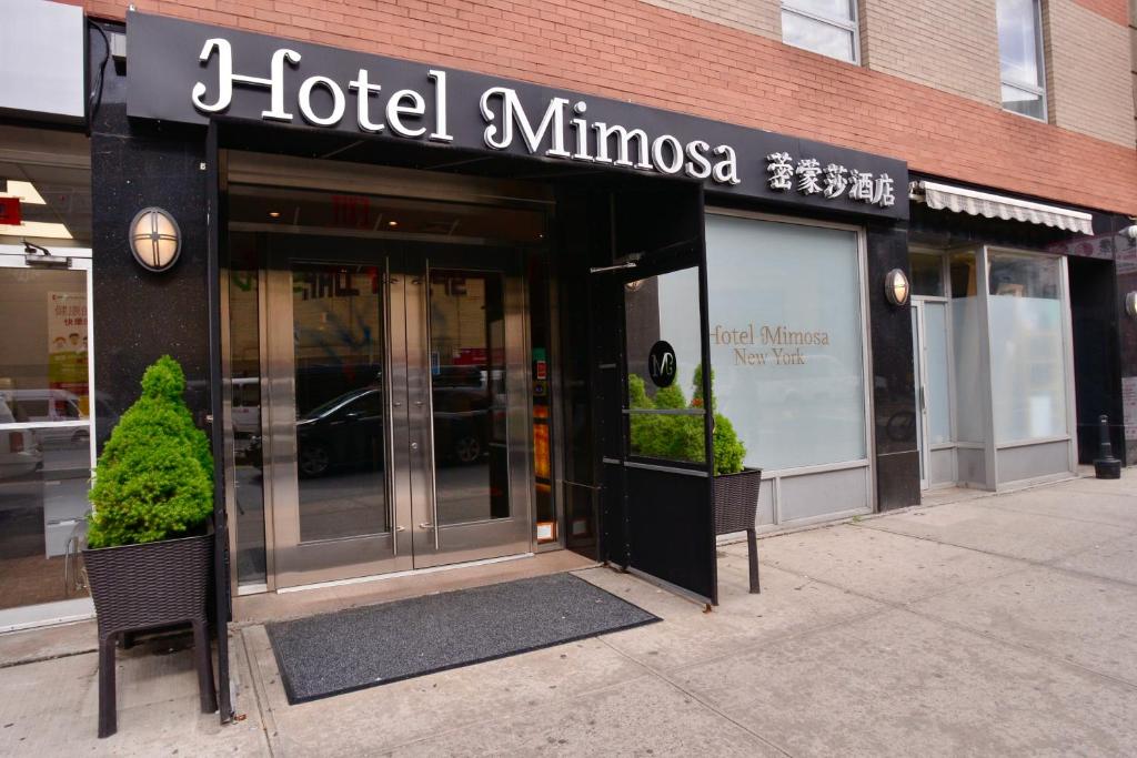 a hotel entrance with two chairs in front of a building at Hotel Mimosa in New York