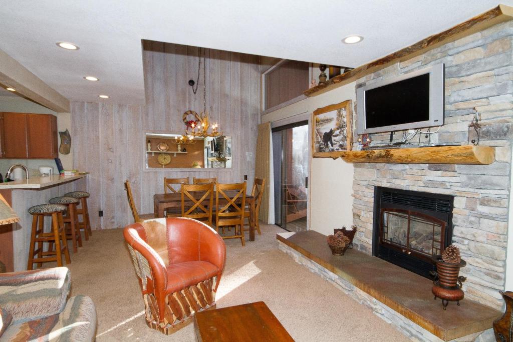 a living room with a fireplace with a tv above it at Mammoth Ski & Racquet Club #86 in Mammoth Lakes