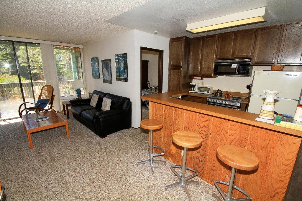 a kitchen with a bar and a living room with a couch at Crestview #17 in Mammoth Lakes