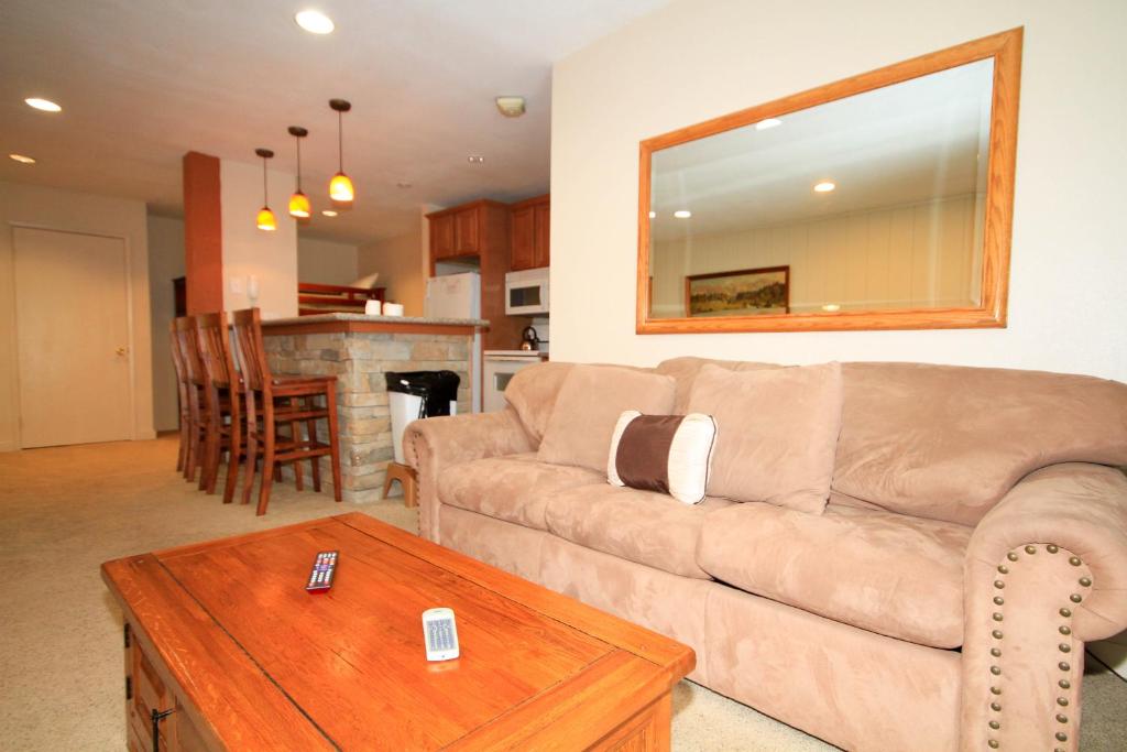 a living room with a couch and a table at Crestview #63 in Mammoth Lakes