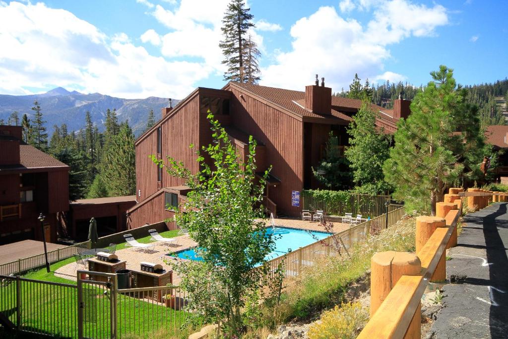 a building with a swimming pool in front of it at Mammoth Ski & Racquet Club #67 in Mammoth Lakes