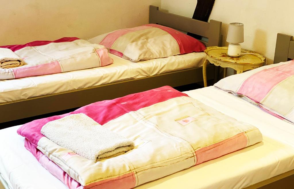 two beds with towels on top of them in a room at Agroturystyka Siołki in Siodłkowice