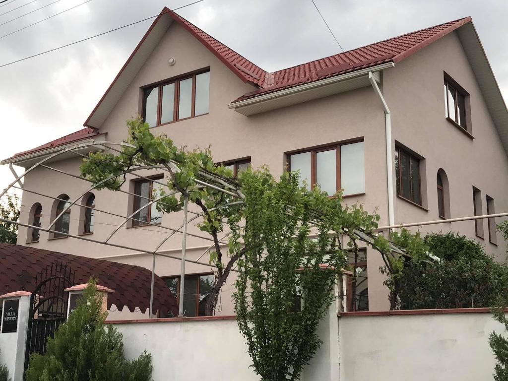 a white house with a red roof at Villa Winery in Cricova