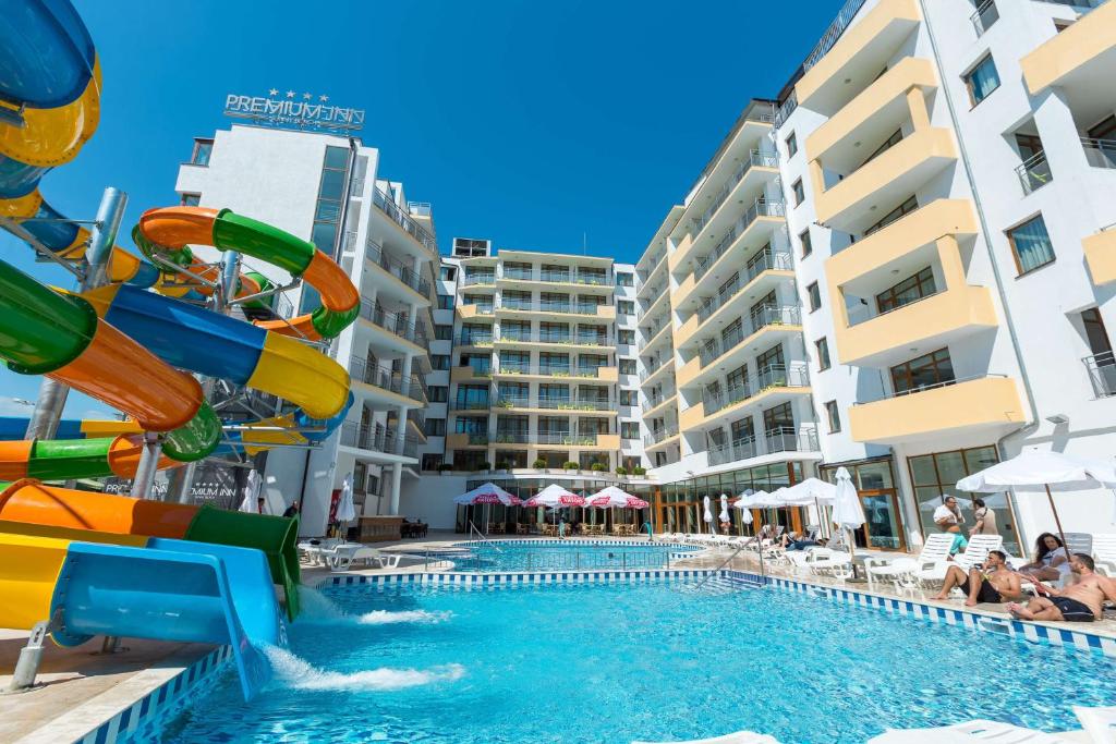 a pool with a water slide in a resort at Best Western PLUS Premium Inn in Sunny Beach