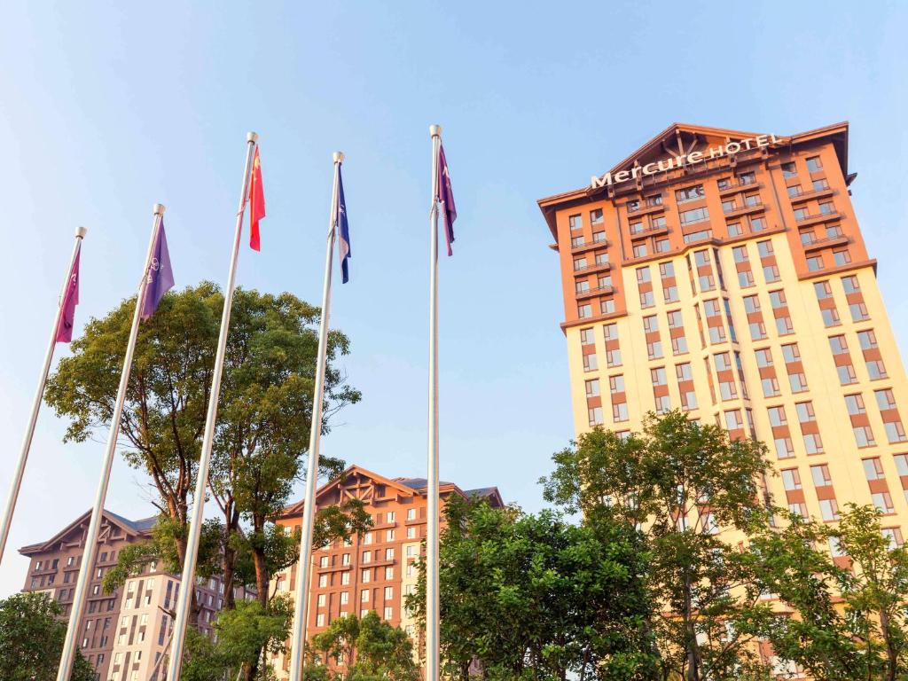 a group of flags in front of a building at Mercure Nanchang Sunac in Nanchang