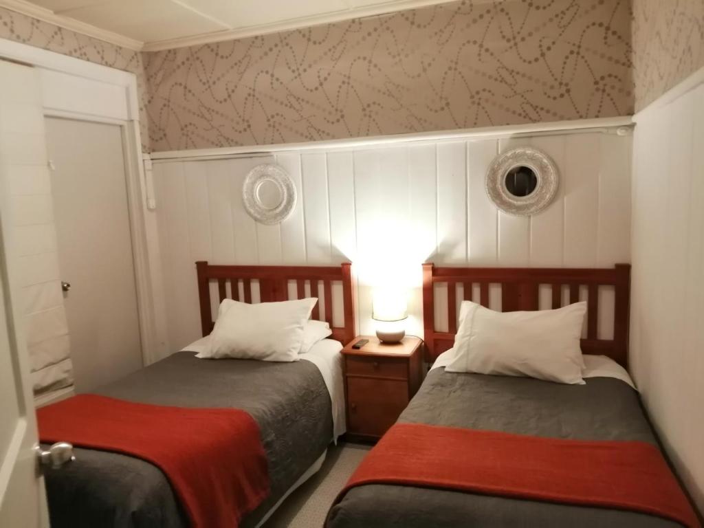 Ένα ή περισσότερα κρεβάτια σε δωμάτιο στο Hostal Mackay Temuco