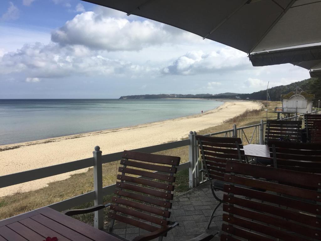 a view of a beach with chairs and the ocean at Strandwohnungen Sellin in Ostseebad Sellin