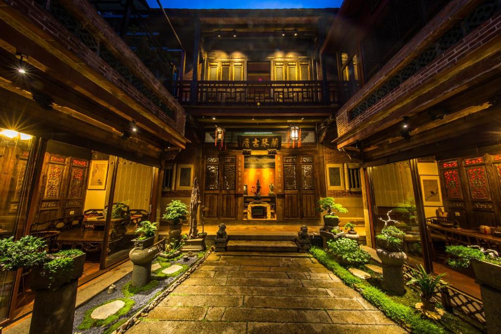 a large building with a staircase in the middle at Xiamen Lanqin Gucuo Mansion in Xiamen