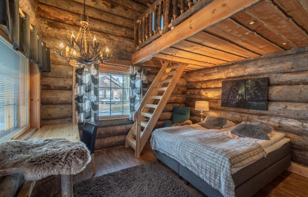a bedroom in a log cabin with a bed and a ladder at Wilderness Hotel Nellim & Igloos in Inari