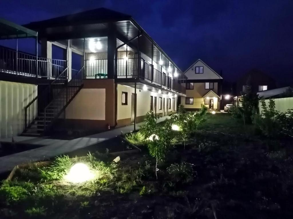 a house with lights in the yard at night at Заветы Ильича in Vityazevo