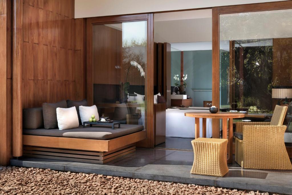 a living room with a couch and a table at Anantara Chiang Mai Resort in Chiang Mai