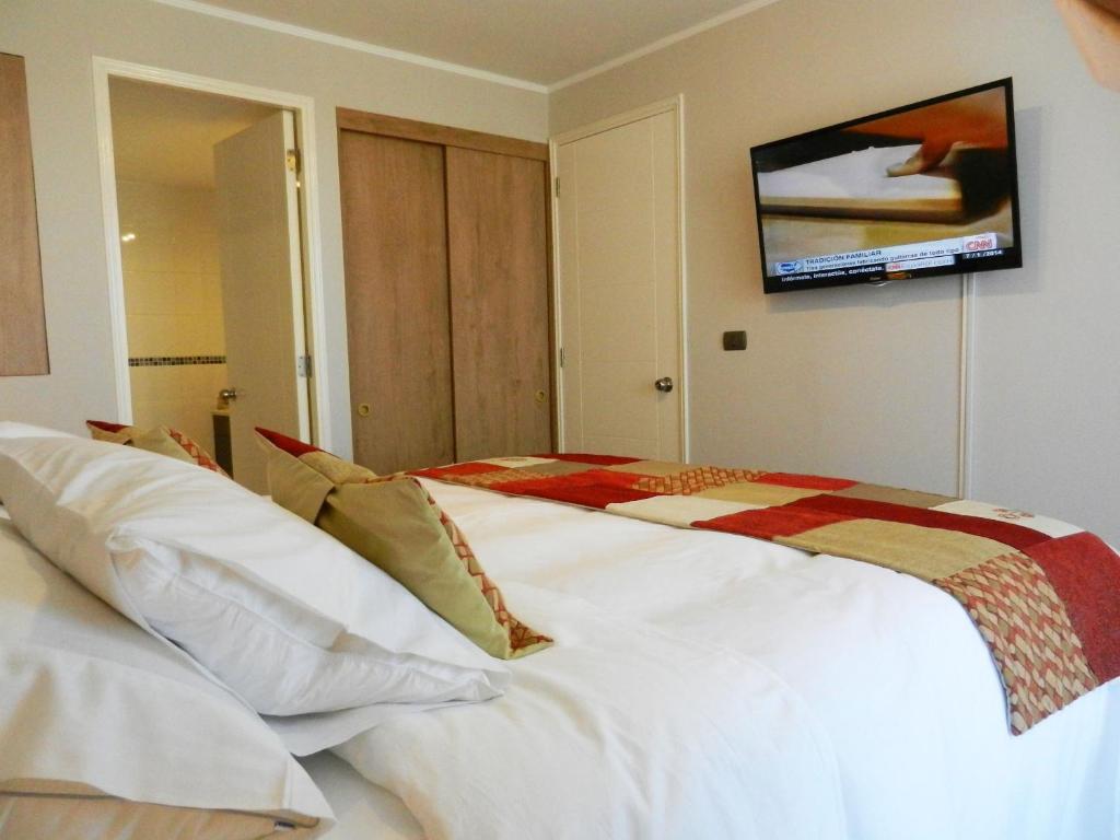 Postel nebo postele na pokoji v ubytování Apartamentos Terrazas de Talca