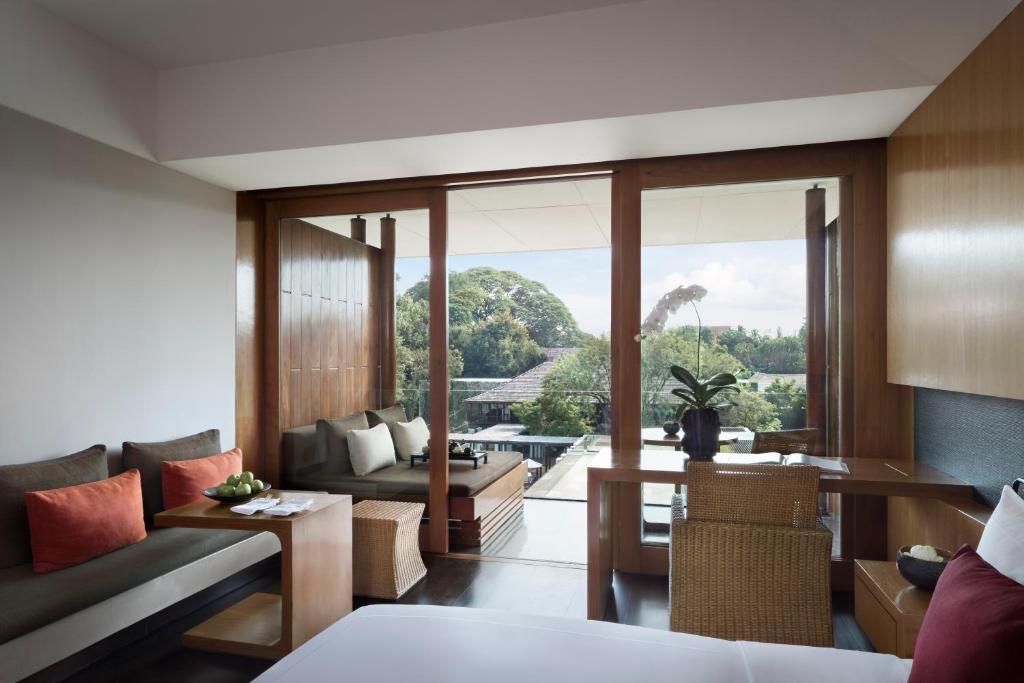 a living room with a couch and a table at Anantara Chiang Mai Resort in Chiang Mai