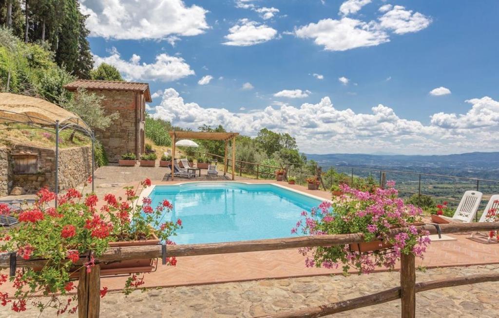 a swimming pool in a garden with flowers at Il Moraiolo - Idromassaggio & Sauna con vista! in Loro Ciuffenna