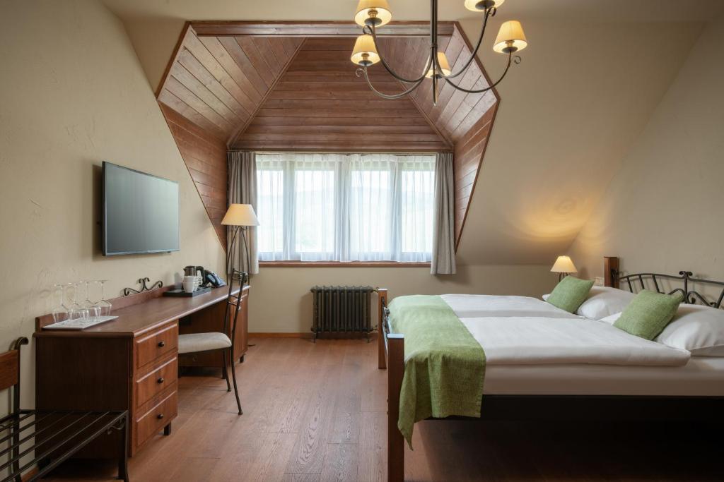 Postel nebo postele na pokoji v ubytování Resort Sobotín