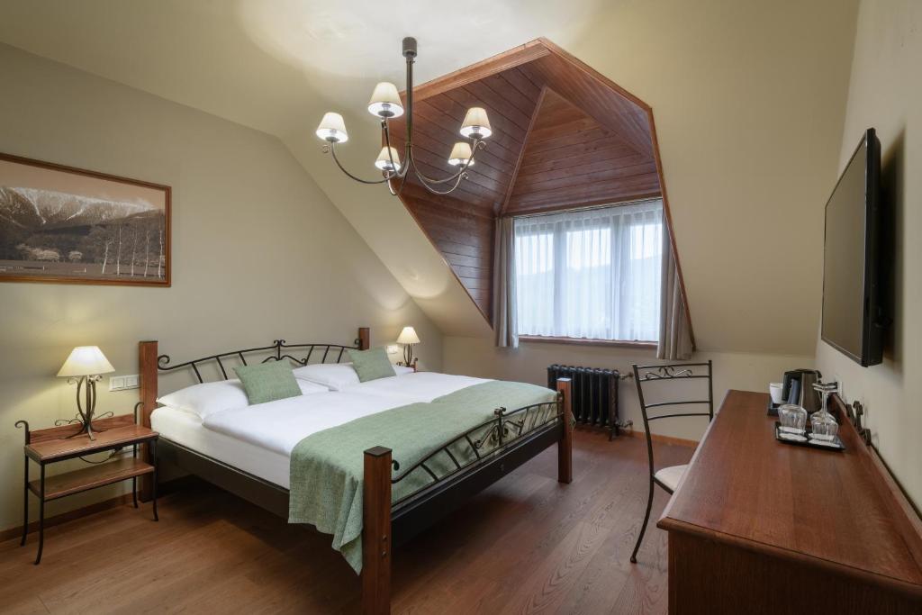 Postel nebo postele na pokoji v ubytování Resort Sobotín
