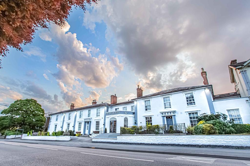 a large white building on the side of a street at Grosvenor Hotel in Stratford-upon-Avon