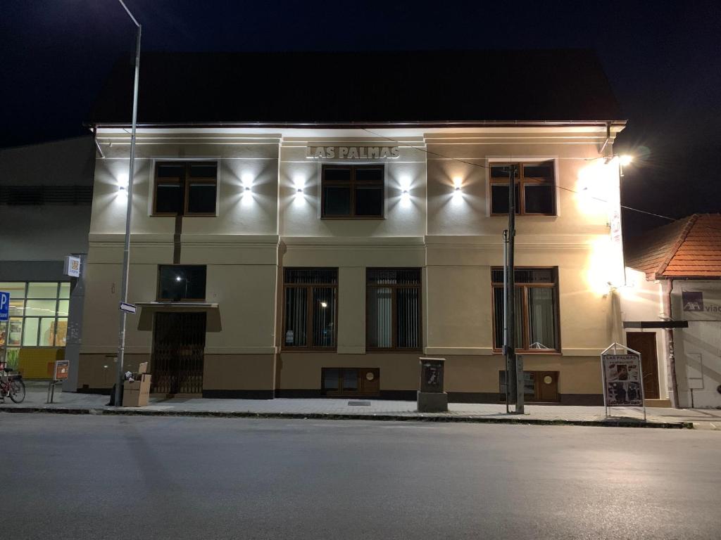 a white building with lights on top of it at LAS PALMAS ROOMS in Štúrovo