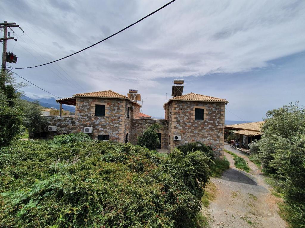 an old stone house on top of a hill at Frigano 1 in Stoupa