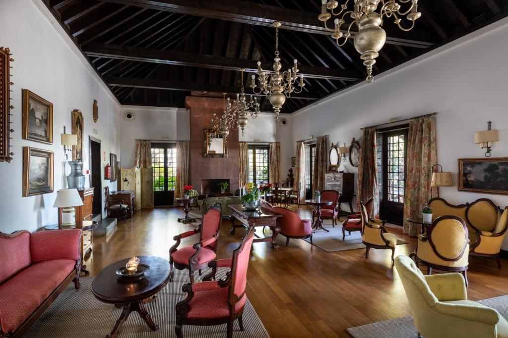 a living room filled with furniture and a chandelier at Parador de La Gomera in San Sebastián de la Gomera