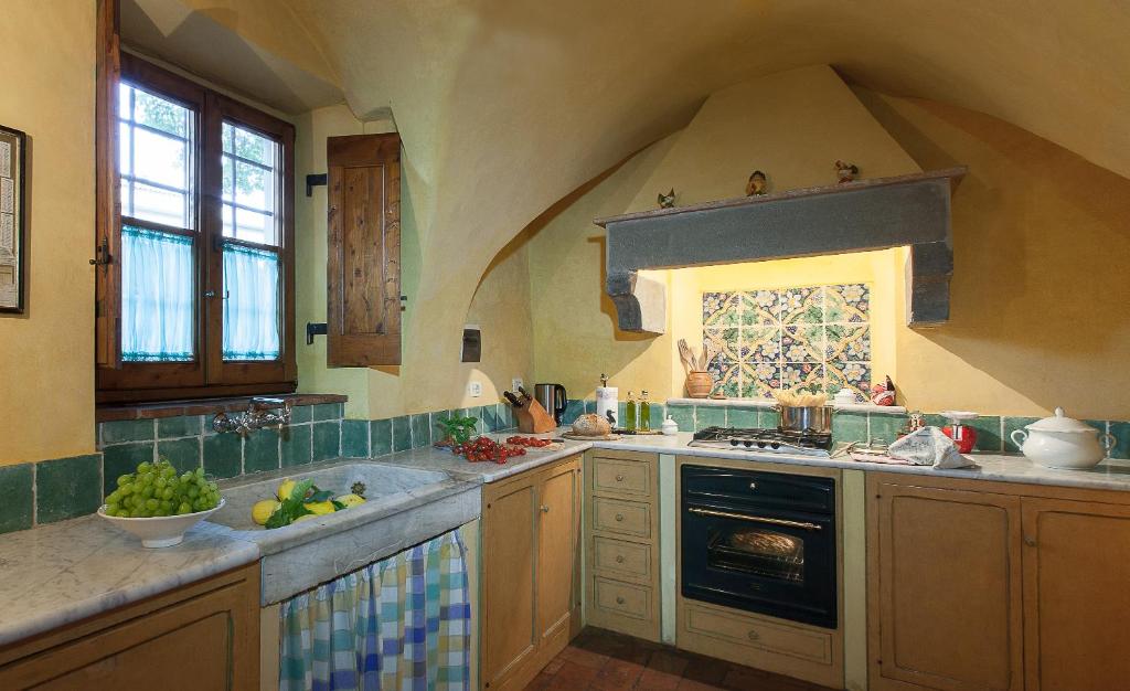 a kitchen with a sink and a stove top oven at Villa Il Paradisino in Sesto Fiorentino