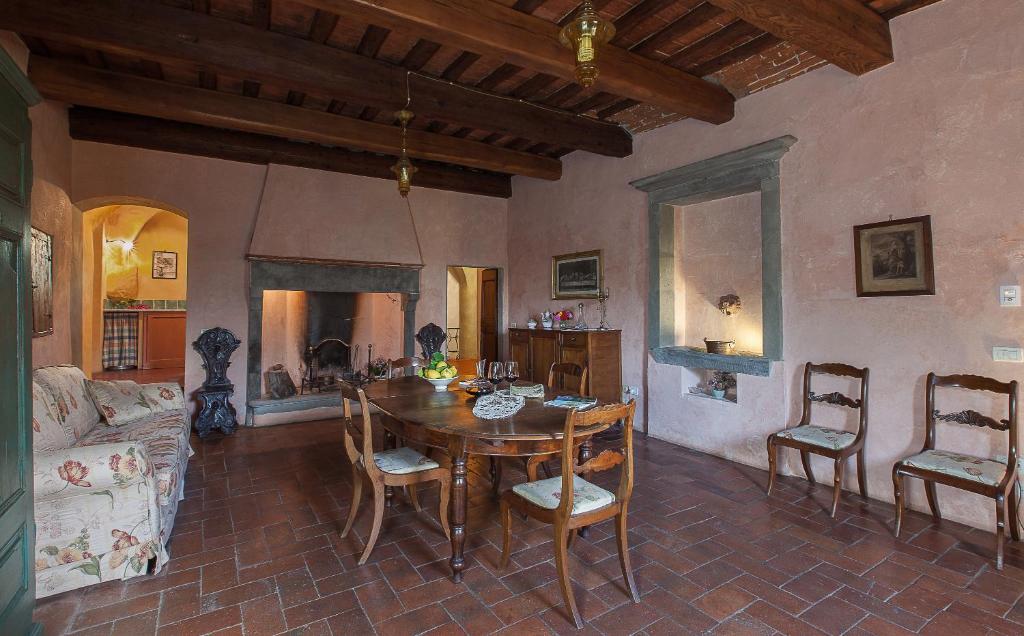 a living room with a wooden table and chairs at Villa Il Paradisino in Sesto Fiorentino