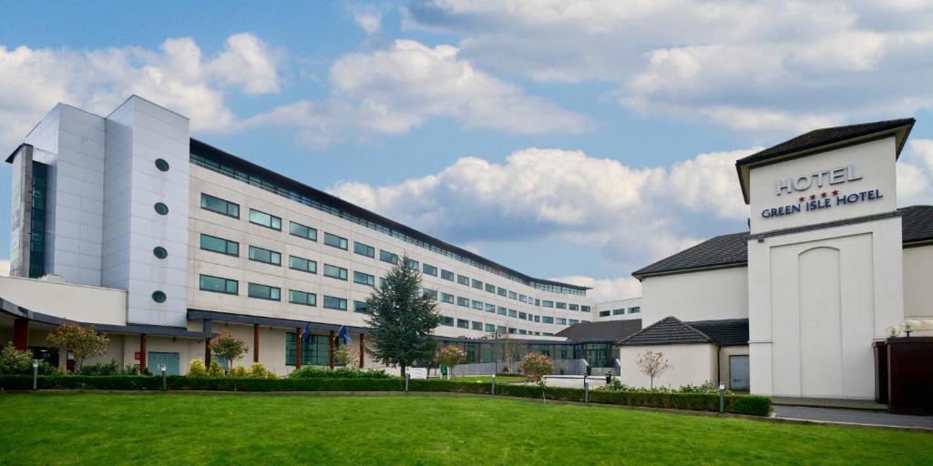 a large white building with a lawn in front of it at Green Isle Hotel, Dublin in Clondalkin