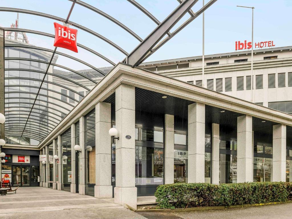 a building with a lot of windows and a red flag at ibis Luzern Kriens in Lucerne