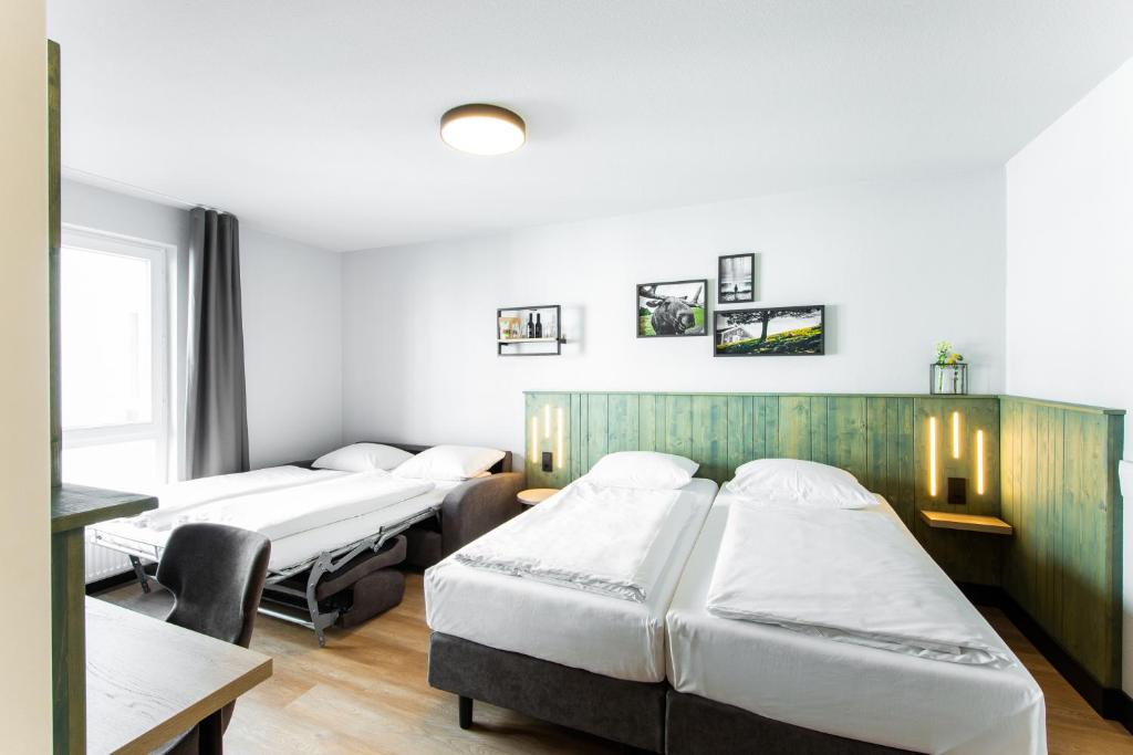 Postel nebo postele na pokoji v ubytování fjord hotel berlin