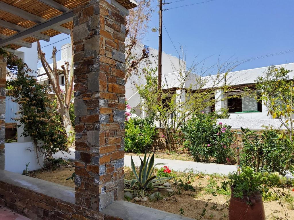 a brick column in a garden with a house in the background at Nefeli in Livadi