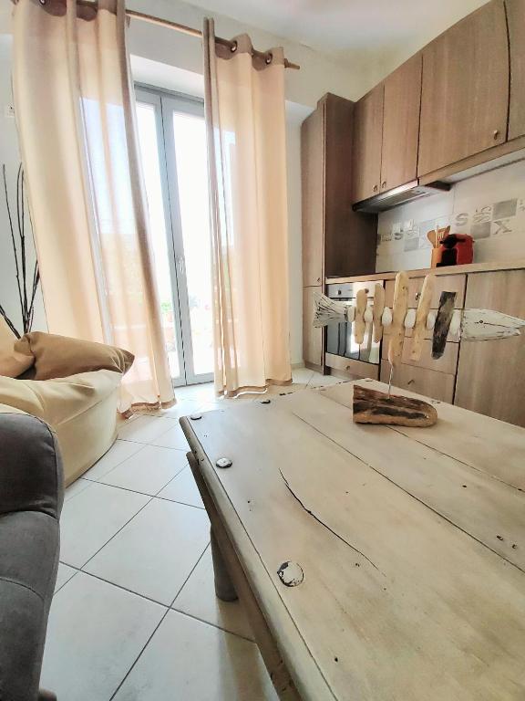a kitchen with a wooden table in a living room at Nefeli in Livadi