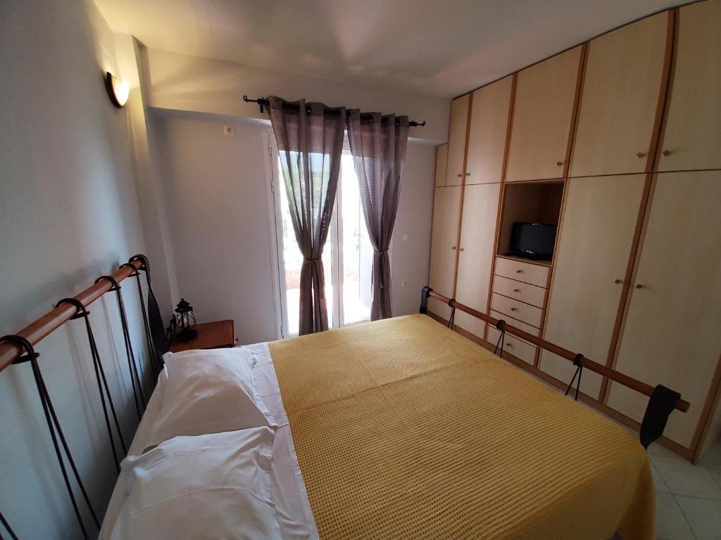 a bedroom with a bed and a window at Nefeli in Livadi