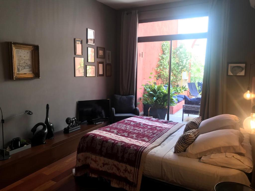 a bedroom with a bed and a large window at Les Chambres de l'Abbaye in Marseille