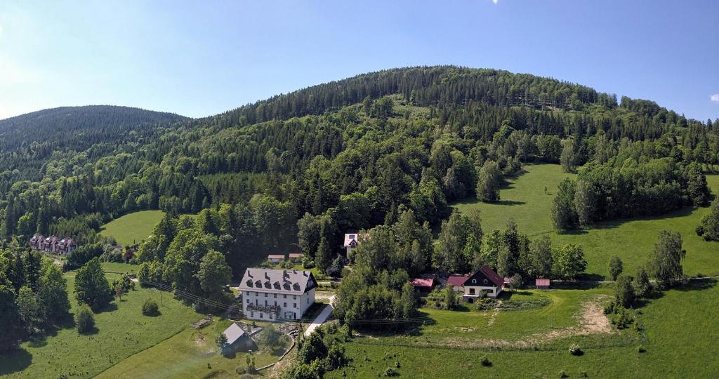 an aerial view of a house in the middle of a mountain at Villa Panorama in Stronie Śląskie