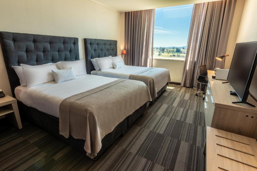 Postel nebo postele na pokoji v ubytování MDS Hotel Chillan