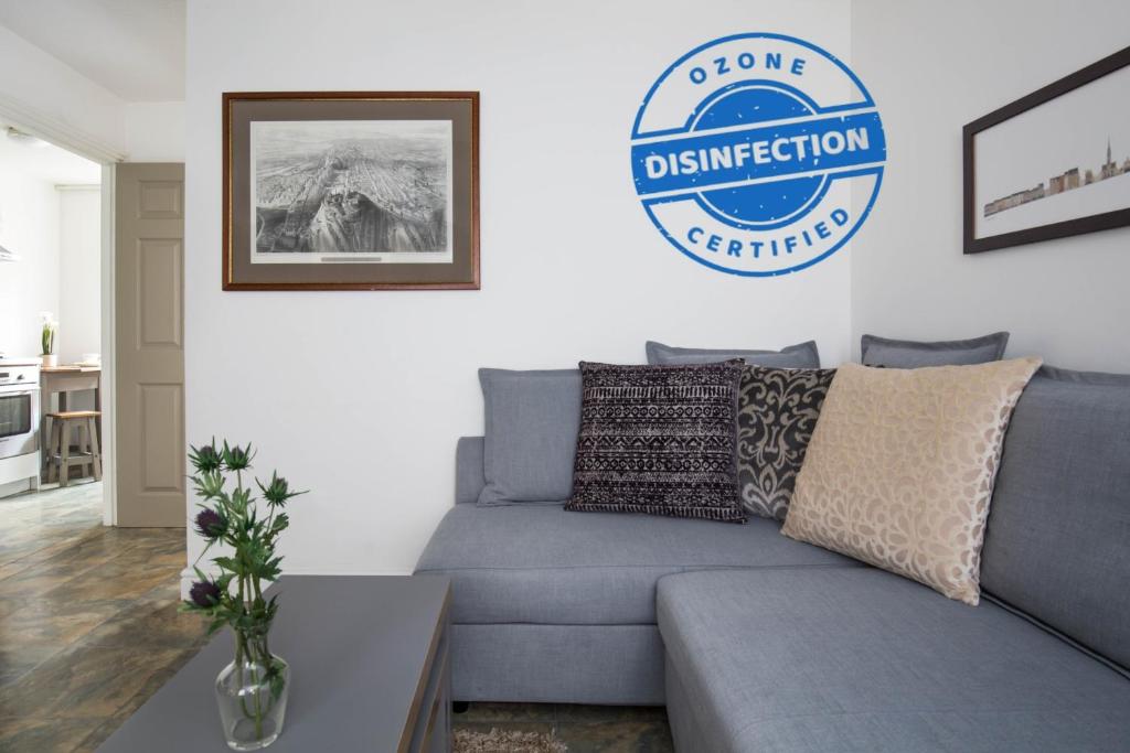 a living room with a couch and a sign that reads done construction certification at Grassmarket Apartment in Edinburgh